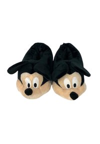 Pantofole di peluche nere e beige a forma del volto di un personaggio dei cartoni animati, con grandi occhi, un naso e orecchie. Texture morbida e design arrotondato.