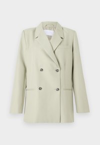 Dobbeltradet blazer i lysegrønn stoff. Har med noterte klaffer, en brystlomme, og to frontlommer med mørke knapper.