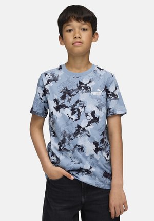 Light blue T-shirt with a black and navy camo pattern, short sleeves, round neck, and white Puma logo on the left chest.