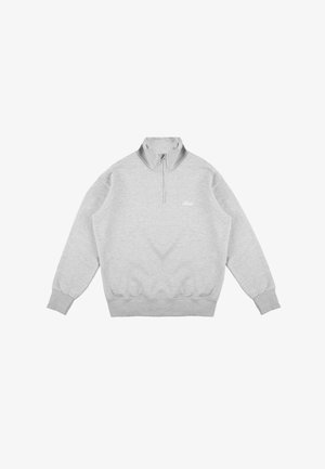 Jasnoszara bluza z ćwierć zamkiem, prążkowanymi mankietami i dołem oraz małym logo na lewej piersi. Wykonana z miękkiej, teksturowanej tkaniny.