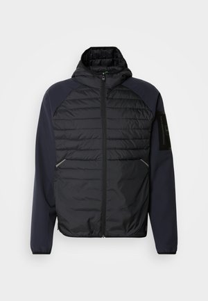 Hooded jacket with a black quilted front, navy blue sleeves, zippered closure, and side pockets. Features a logo patch on the sleeve.