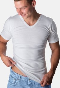 White v-neck t-shirt made of soft cotton material, fitted design, short sleeves, with a smooth texture and minimal detailing.