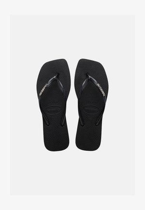 Black rubber flip-flops with textured soles and thin straps featuring the Havaianas logo in white on a plain background.