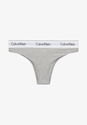 Gray cotton thong with a white elastic waistband featuring the "Calvin Klein" logo in black. Smooth texture and simple design.