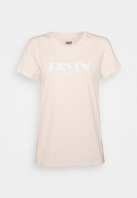 Světlý béžový bavlněný tričko s krátkým rukávem, na kterém je bílé logo Levi's přes hruď. Klasický kulatý výstřih a měkká textura.