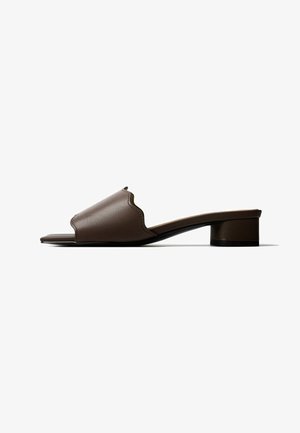 Brown leather open-toe mule with a low block heel and a scalloped edge on the upper strap, shown in side profile on a white background.