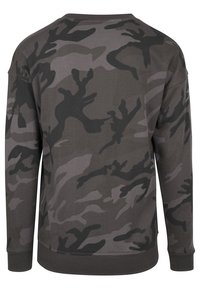 Sudadera de camuflaje en tonos de gris. Presenta un cuello redondo, mangas largas y puños de canalé. Tejido suave con un patrón mezclado.