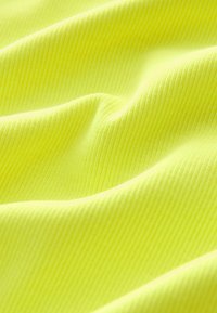 Ribbed fabric in bright neon yellow, displaying soft texture and gentle folds, highlighting its vibrant color and material design.