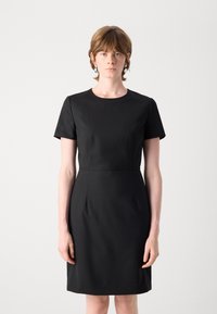 Black short-sleeved dress with a round neckline, tailored fit, and subtle pleats, made from smooth fabric with a matte finish.
