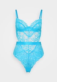 Lace bodysuit in bright blue featuring a floral pattern, adjustable straps, and a fitted waist. Made of sheer lace material.