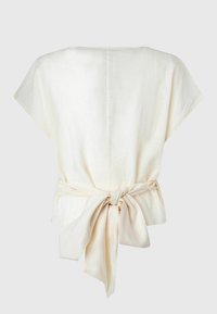 Kremowy, lekki top z krótkim rękawem i zawiązywaniem z tyłu. Gładka tekstura i luźny krój, z centralnym szwem.