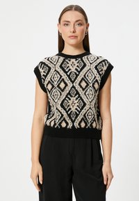 Top negro de punto sin mangas con patrones geométricos texturizados en crema y beige, con cuello y dobladillo acanalados, que presenta un diseño intrincado.