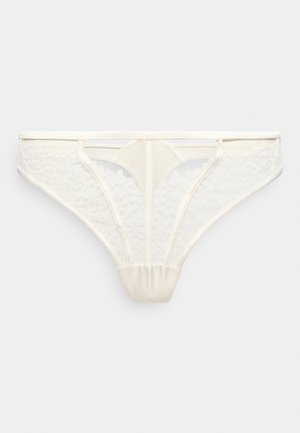 Weißer Spitzen-Damen-String mit floralen Mustern und transparenten Netzpaneelen, ausgestattet mit einem schmalen Bund und minimaler Bedeckung.