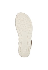 Light beige sandal with a white textured rubber sole, featuring a smooth footbed and adjustable strap for comfort.