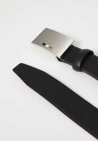 Black leather belt with a sleek, rectangular silver buckle. Buckle features a small logo and three color accents: black, white, and orange.