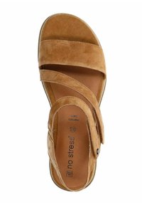 Brown suede sandal with two wide adjustable straps, a cushioned footbed, and a round toe. Textured sole visible on the outer edge.