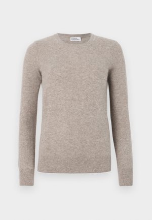 Pull beige en tissu doux, avec un col arrondi, des manches longues et des poignets et un ourlet côtelés. Texture lisse, design minimal.