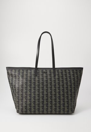 Bolsa tote preta espaçosa com um padrão geométrico em bege. Apresenta alças resistentes em couro preto e uma forma plana. Material sintético texturizado.