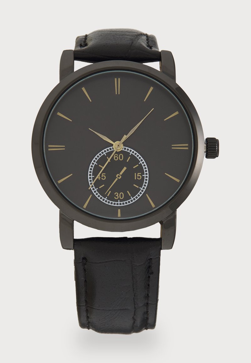 Black watch with a round face, gold hour markers, and a subdial displaying seconds. Features a black leather strap with a textured finish.