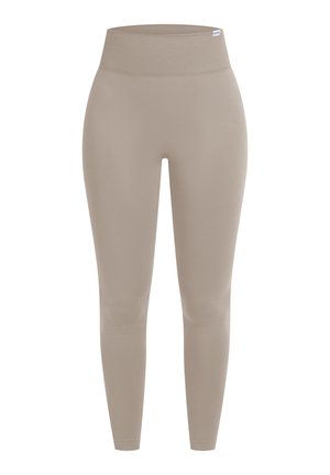 Beige legíny s vysokým pasem vyrobené z hladké, elastické látky, s bezešvým designem a tapered střihem, sahajícími až k kotníkům.