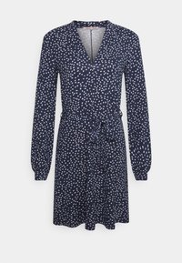 Mörkblå klänning med långa ärmar och omslagdesign. Har ett subtilt prickigt mönster i vitt och ljust rosa, med ett knyte i midjan.