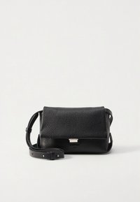 Black leather crossbody bag with a textured finish, a flap closure, and a silver-tone hardware accent. Adjustable strap included.