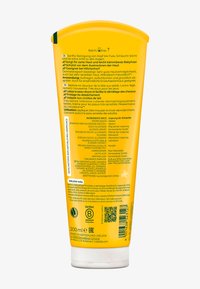 Gul klämtub med rundad topp, med svart och vit text samt en tydlig ingredienslista. Innehåller 200 ml babywash.