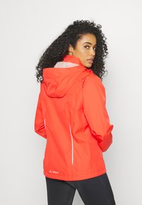 Red waterproof jacket with a hood, featuring white reflective accents and a breathable mesh lining. Lightweight, designed for outdoor wear.
