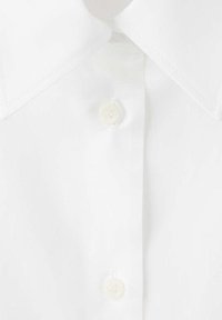 Gros plan sur le col et la patte de boutonnage d'une chemise blanche avec deux boutons blancs attachés.