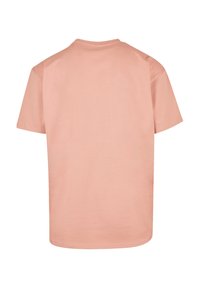Short-sleeve t-shirt in soft, lightweight fabric; pale pink color with a simple round neckline and clean edges.