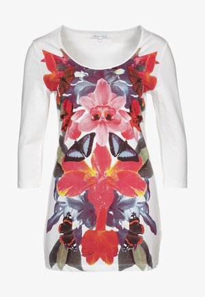 Biała bluzka z długim rękawem z żywym wzorem kwiatów i motyli w kolorach czerwonym, różowym i niebieskim. Miękki materiał z okrągłym dekoltem.