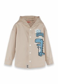 Camicia a maniche lunghe beige con cappuccio, caratterizzata da una grafica di un dinosauro blu e la scritta "Let's Pawr". Progettata con bottoni frontali e tessuto testurizzato.