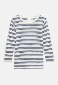 Camisola de manga longa às riscas em branco e azul marinho, com riscas horizontais. Feita de um material texturizado, possui um decote redondo e ajuste padrão.