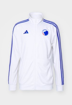 Chaqueta deportiva blanca con rayas azules, con cierre frontal y logo. Hecha de una tela suave, con puños y dobladillo acanalados.
