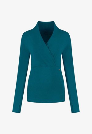 Teal long-sleeve wrap top with a V-neckline and side slits. Made of soft fabric with a smooth texture, featuring subtle stitching details.