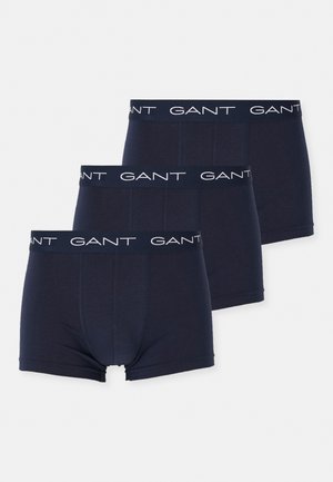 Trois paires de boxers bleu marine en coton doux, dotés d'une ceinture élastique blanche avec logo répété.