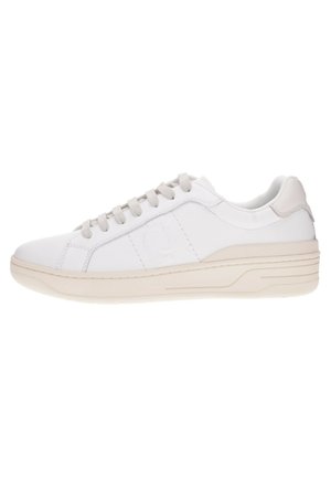 Baskets blanches avec une tige en cuir lisse, des accents beiges, un bout rond, des lacets plats et une semelle en caoutchouc texturée. Logo discret sur le côté.