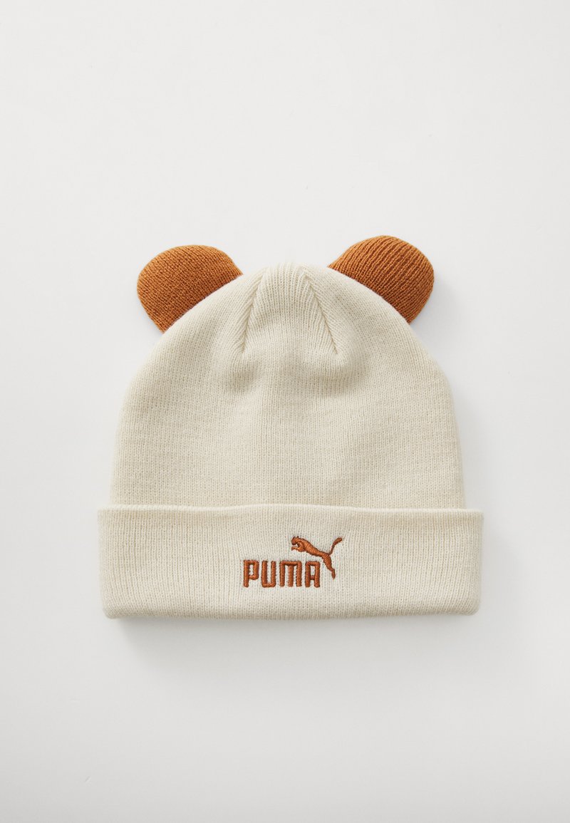 Krēmskrāsas adīta cepure ar brūniem ausim līdzīgiem akcentiem, ar salocītu malu un izšūtu "PUMA" logotipu rūsas krāsā.