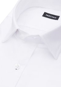 Biała koszula shirtowa z klasycznym kołnierzykiem, zapięciem na guziki, gładką fakturą i tkanym wykończeniem. Metka wewnątrz głosi "PRÓCHNIK."