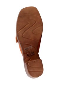 Brown rubber shoe sole with a textured surface, featuring a zigzag pattern and a slight heel. Side profile shows an orange upper section.