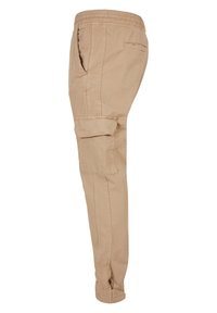 Beige Cargohose mit elastischem Bund, seitlichen Taschen und aufrollbarem Saum. Hergestellt aus einem weichen, strapazierfähigen Stoff mit glatter Textur.