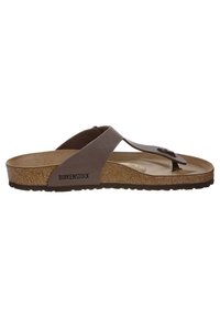 Ruske Birkenstock sandale s korkom kao potplatom, teksturiranim gumiranim đonom i glatkim kožnim trakama. Ima metalni detalj na traci.