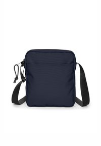 Tummansininen olkalaukku, joka on valmistettu teksturoidusta kankaasta. Varustettu vetoketjukiinnityksellä, säädettävällä hihnalla ja etutaskulla lisäsäilytystä varten.