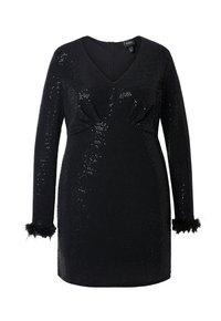 Robe en sequins noirs avec un décolleté en V profond, des manches longues avec des poignets en fausse fourrure, et une silhouette ajustée mettant en valeur la taille.