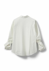White cotton shirt featuring a collar, long sleeves with buttoned cuffs, a relaxed back pleat, and a curved hem.