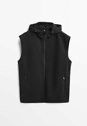 Veste sans manches noire zippée avec capuche et deux poches zippées frontales, posée à plat sur un fond blanc.