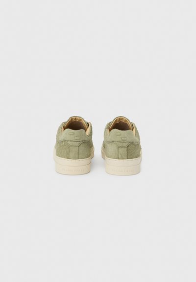 Πράσινα σουέτ αθλητικά παπούτσια με χαμηλό προφίλ, ταμπά δερμάτινη επένδυση και κρεμ ελαστικές σόλες. Διαθέτουν ανάγλυφο λογότυπο στη φτέρνα.