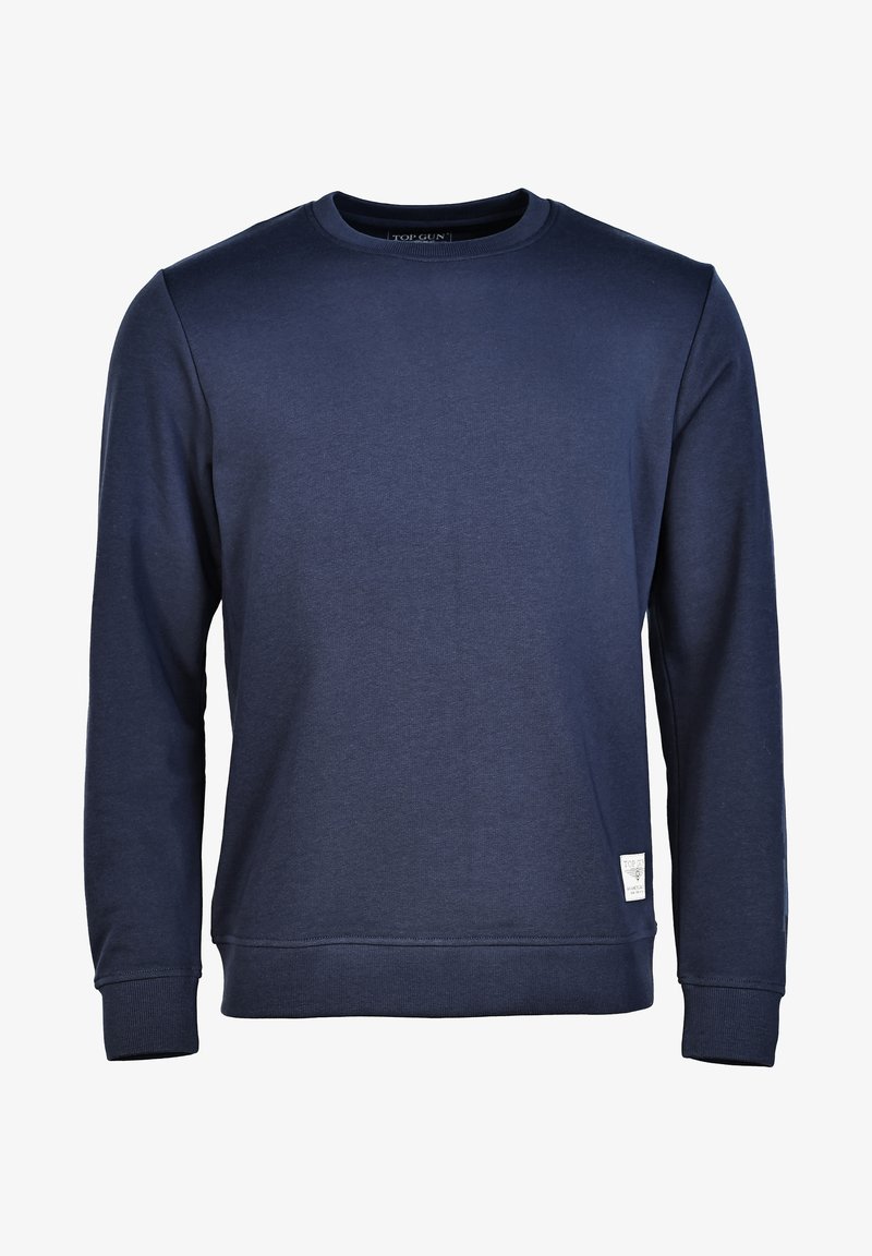 Mørkeblå sweatshirt lavet af blødt stof, med rund halsudskæring og ribbede manchetter. Et lille logoklip vises nederst til venstre foran.