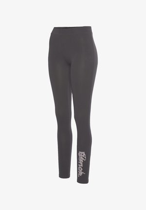 Schwarze Leggings mit hohem Bund, aus dehnbarem Material gefertigt. Auf dem unteren Bein befindet sich ein helles "Bench."-Logo.