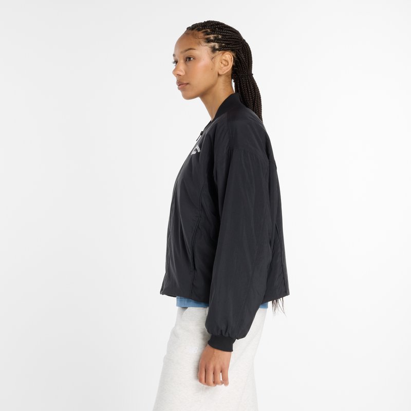 Black lightweight bomber jacket with a zip front, ribbed cuffs, and a round logo on the chest. Smooth texture and cropped design.